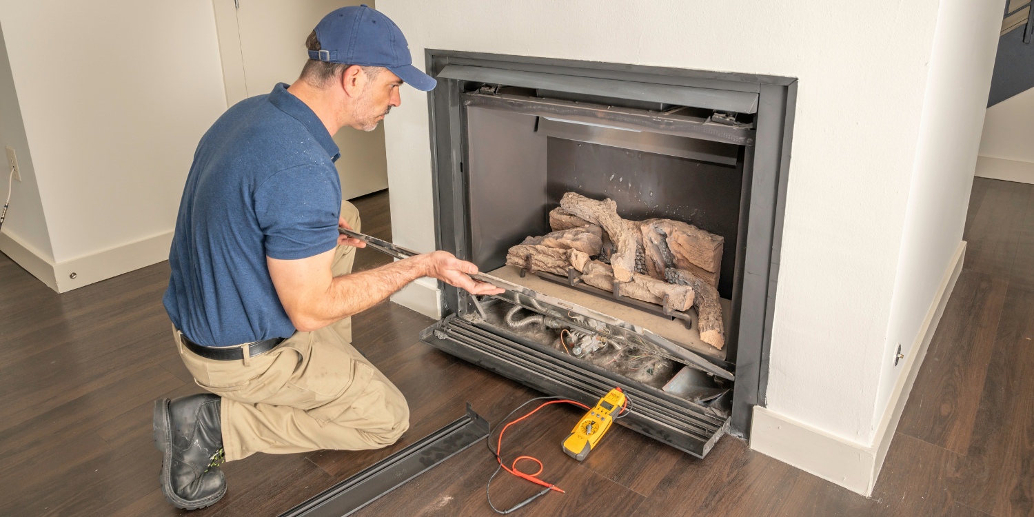 Gas Fireplace tech maintaining fireplace - Does My Gas Fireplace Need Maintenance? Reasons to Call a Pro